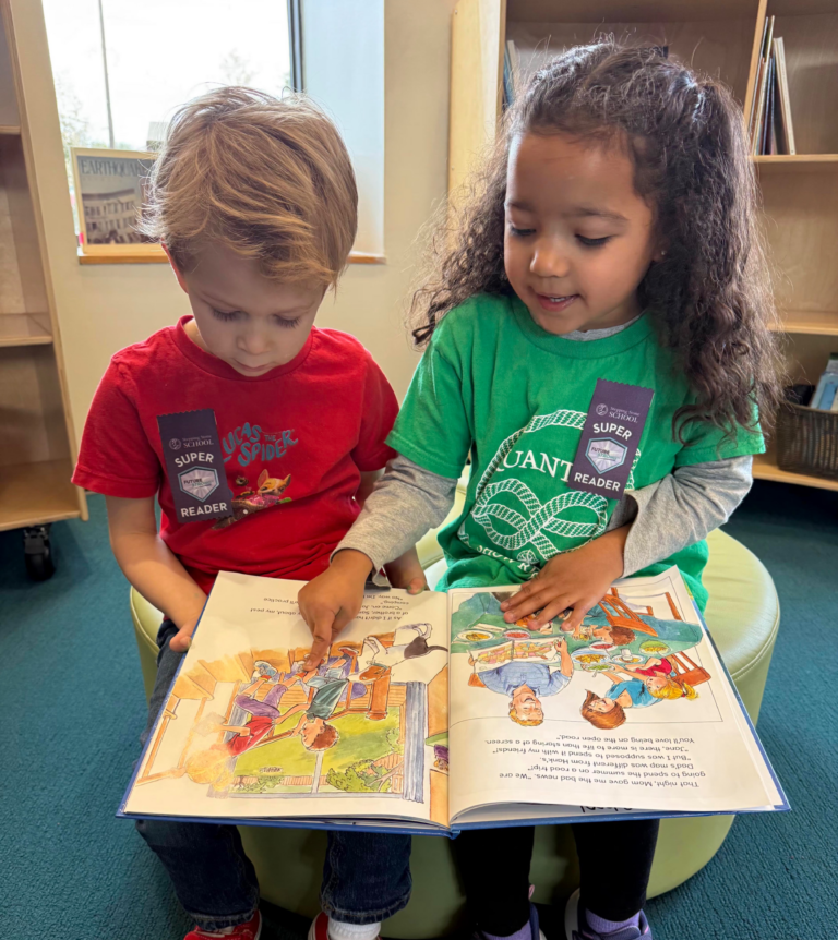 Two young children reading a colorful picture book together in a library setting