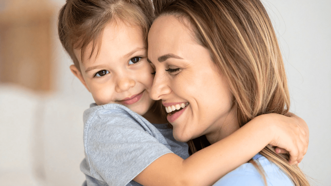 Mother and child sharing a warm embrace and smiling