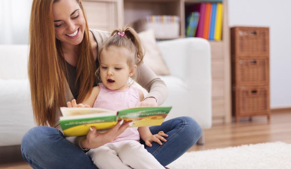 Mother and daughter reading a book together on a cozy living room floor