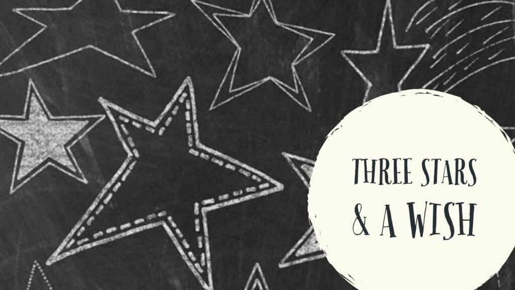 Chalk-drawn stars on blackboard with the text Three Stars and a Wish in a circular frame
