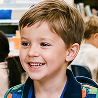 Smiling young boy in a classroom setting