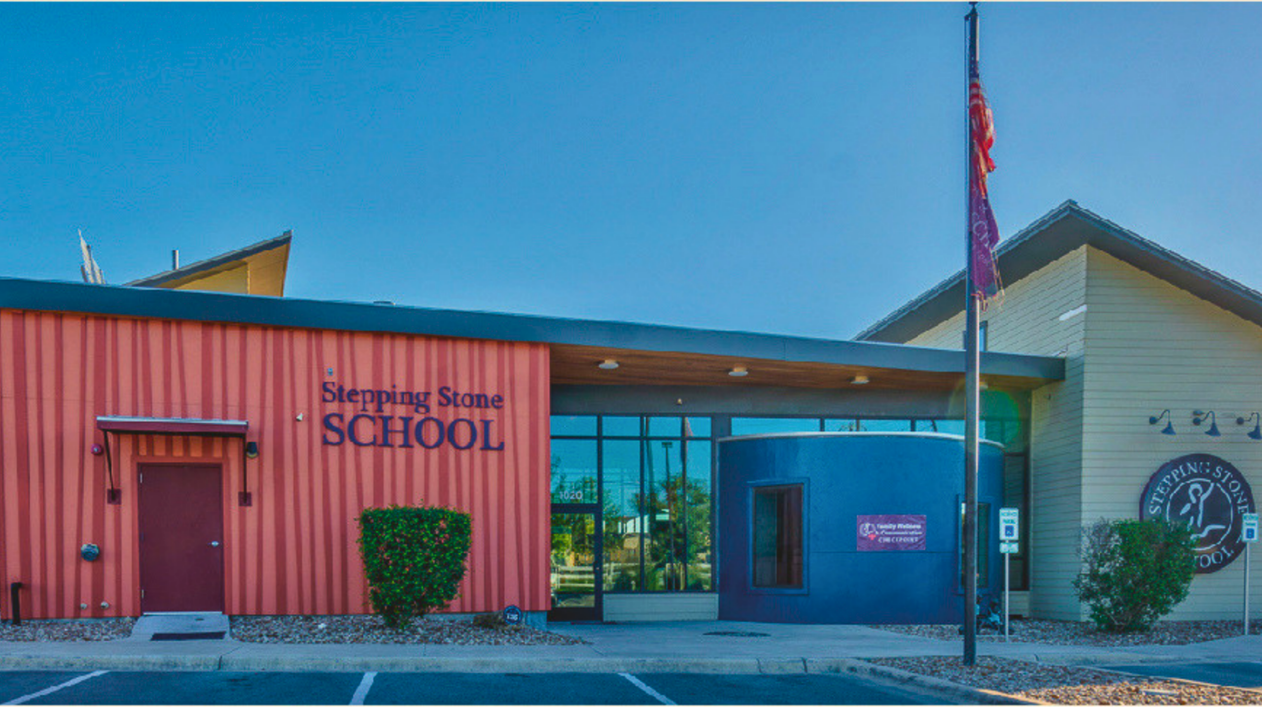 Front view of Stepping Stone School building with blue sky background