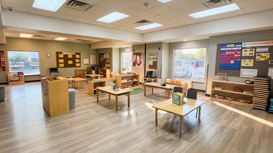 Spacious and organized classroom with tables and educational materials
