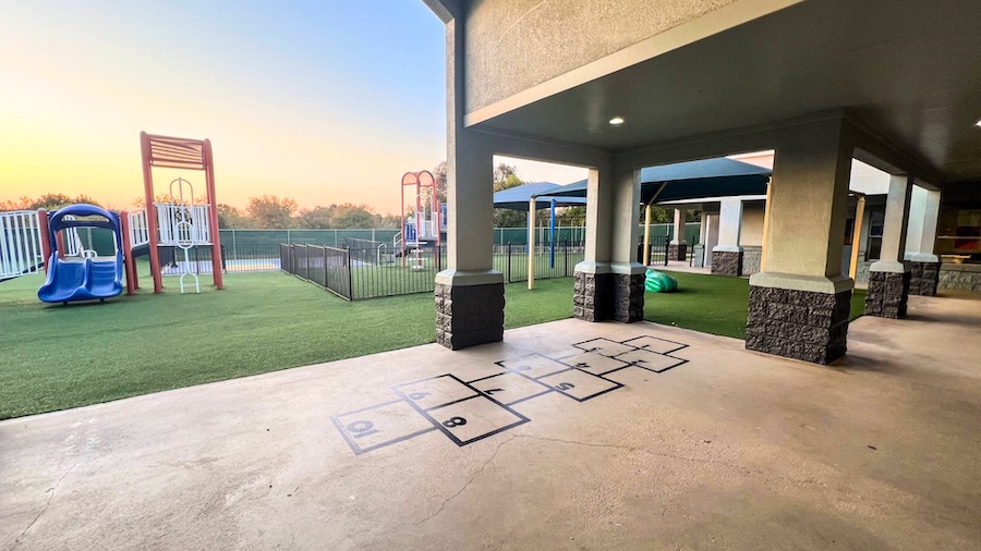 Outdoor playground with slides and hopscotch at sunset
