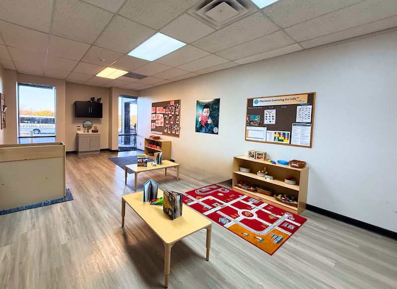 Bright preschool classroom with educational toys and colorful decor on walls and shelves