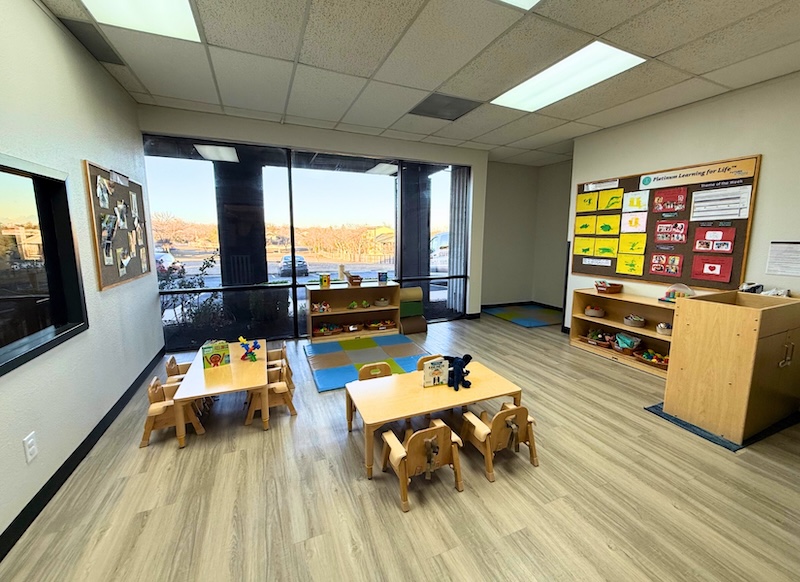 Bright classroom with low tables and educational toys for children learning and play activities
