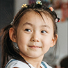 Smiling young girl with colorful hair clips in a casual setting