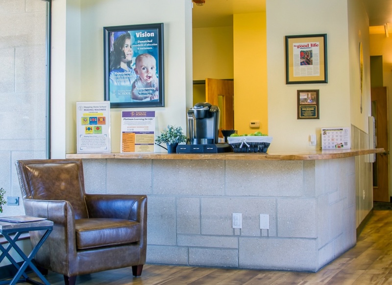 Reception area with a leather chair and coffee maker on the counter